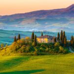 stunning landscape of tuscany - classic italian home surrounded by trees with hills in thre distance - romantic things to do in tuscany